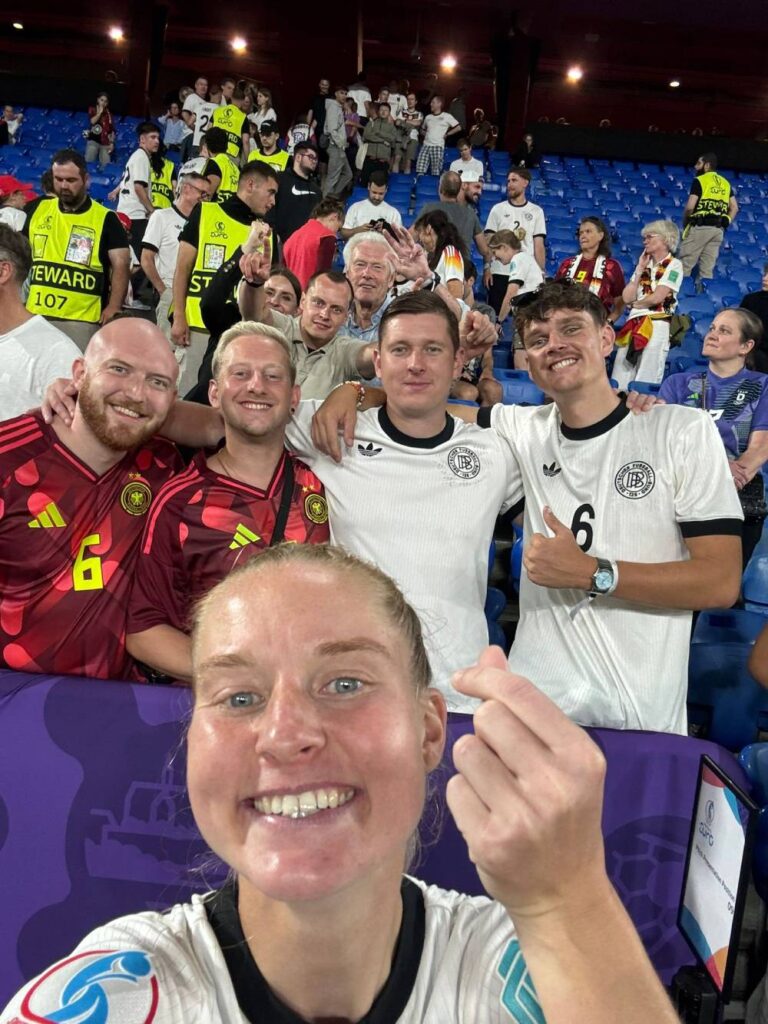 Selfie einer Fußballerin mit einer Menge Menschen im Hintergrund.